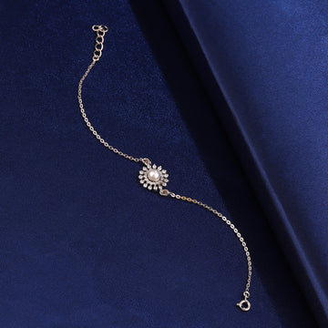 925 silver sunflower pearl bracelet on blue fabric background