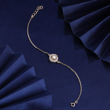 925 silver pearl halo bracelet styled on blue fabric background