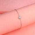 925 silver halo bracelet worn on pink background