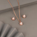 Rose gold pendant set in 925 silver with round center stone and geometric halo design including matching stud earrings