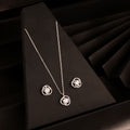 925 silver classic halo pendant necklace set with matching stud earrings displayed on black background