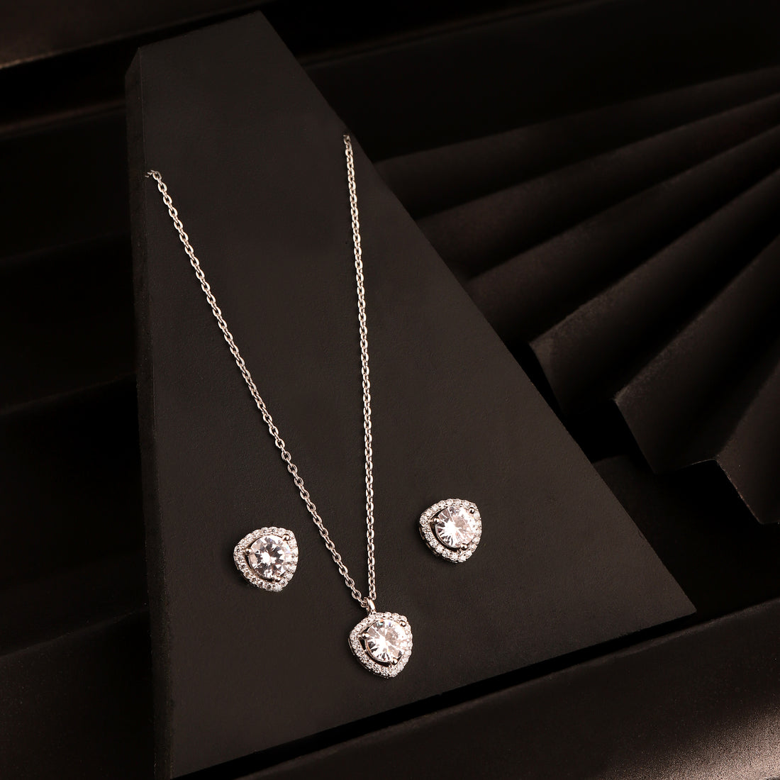 925 silver heart halo pendant necklace set with matching stud earrings on black background