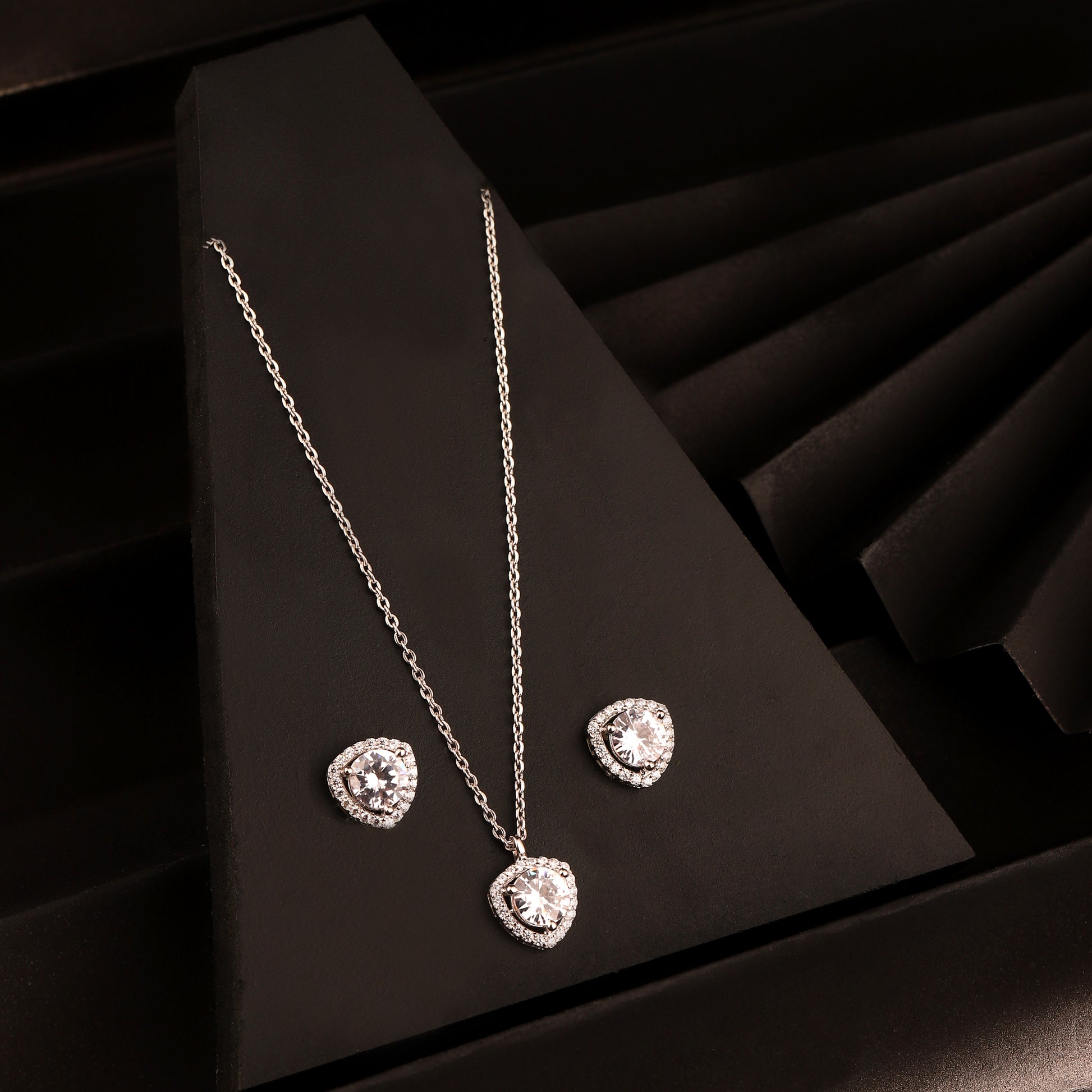 925 silver heart halo pendant necklace set with matching stud earrings on black background