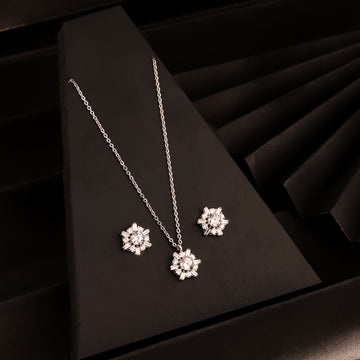 925 silver sunburst pendant necklace set with matching stud earrings on black background