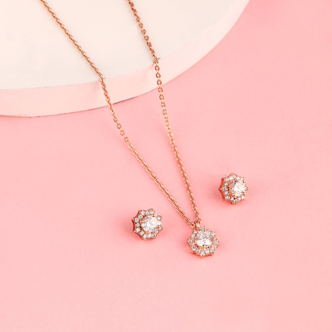 Rose gold floral halo pendant set in 925 silver with zircon stones displayed on soft pink background