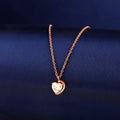 925 silver rose gold heart pendant with half halo stone detail on blue background