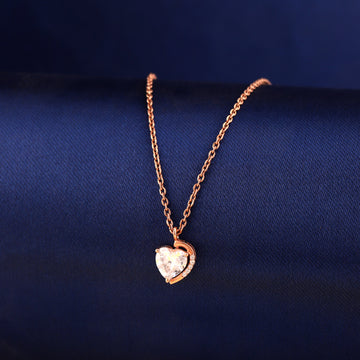 925 silver rose gold heart pendant with half halo stone detail on blue background