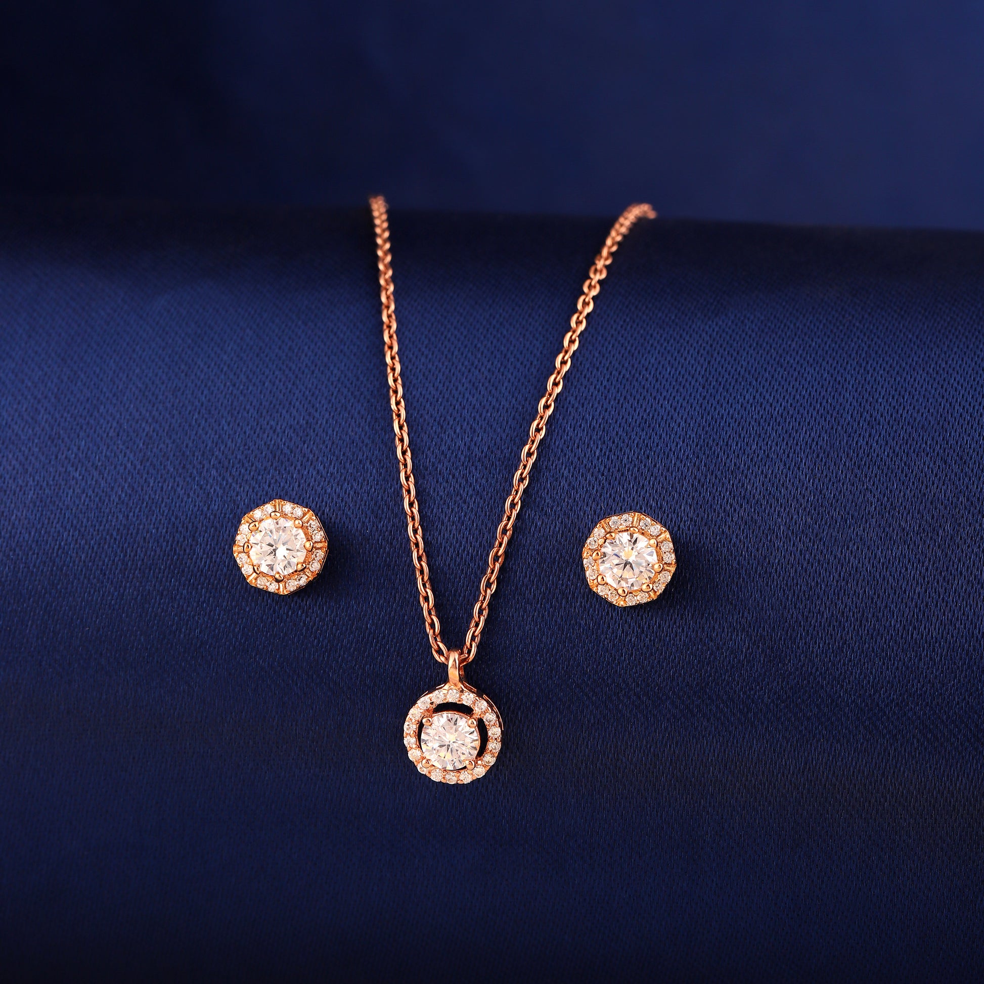925 silver rose gold halo pendant necklace set with matching stud earrings on blue background