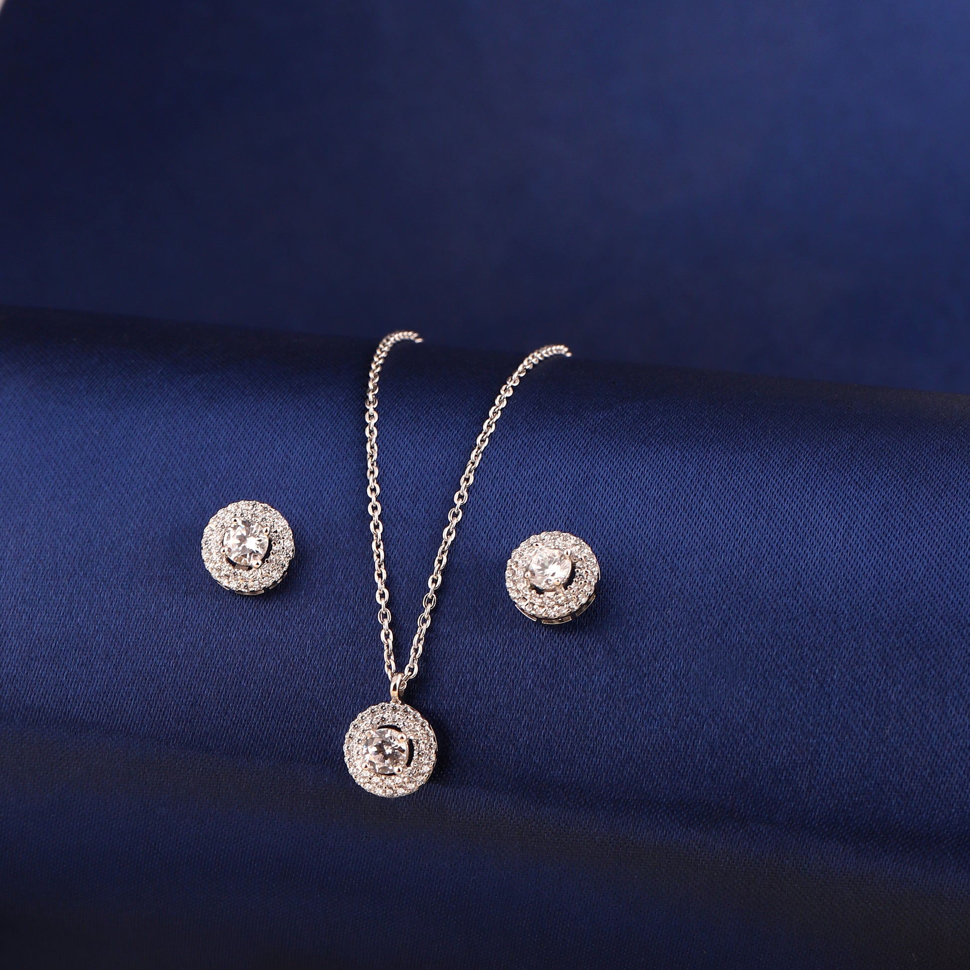 925 silver double halo pendant set with zircon stones displayed on blue fabric