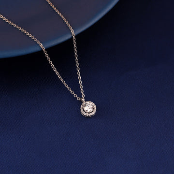 Round halo pendant necklace in 925 silver displayed on blue fabric background