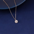 Cushion halo pendant necklace in 925 silver displayed on blue fabric background