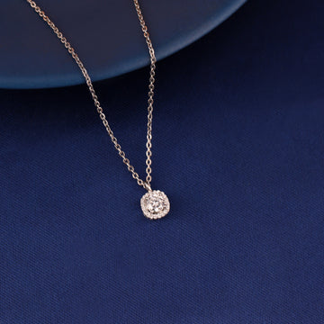 Cushion halo pendant necklace in 925 silver displayed on blue fabric background