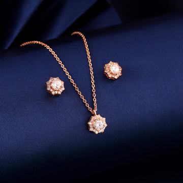 Rose gold 925 silver floral pendant set displayed on blue fabric background