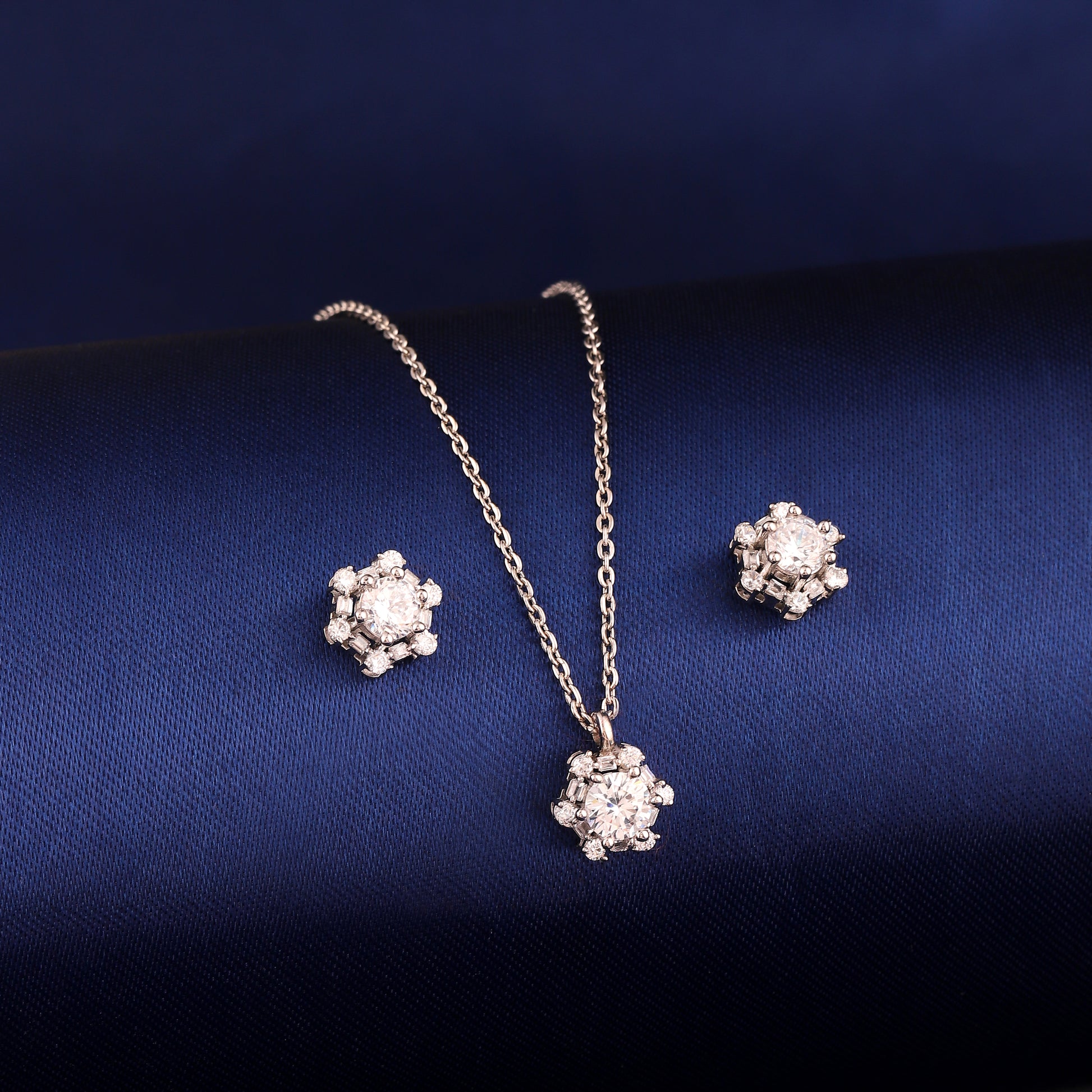 925 silver pendant and earring set styled on dark blue background