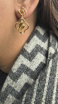 Close-up of 925 silver golden bloom petal drop earrings worn on ear showcasing elegant floral drop silhouette