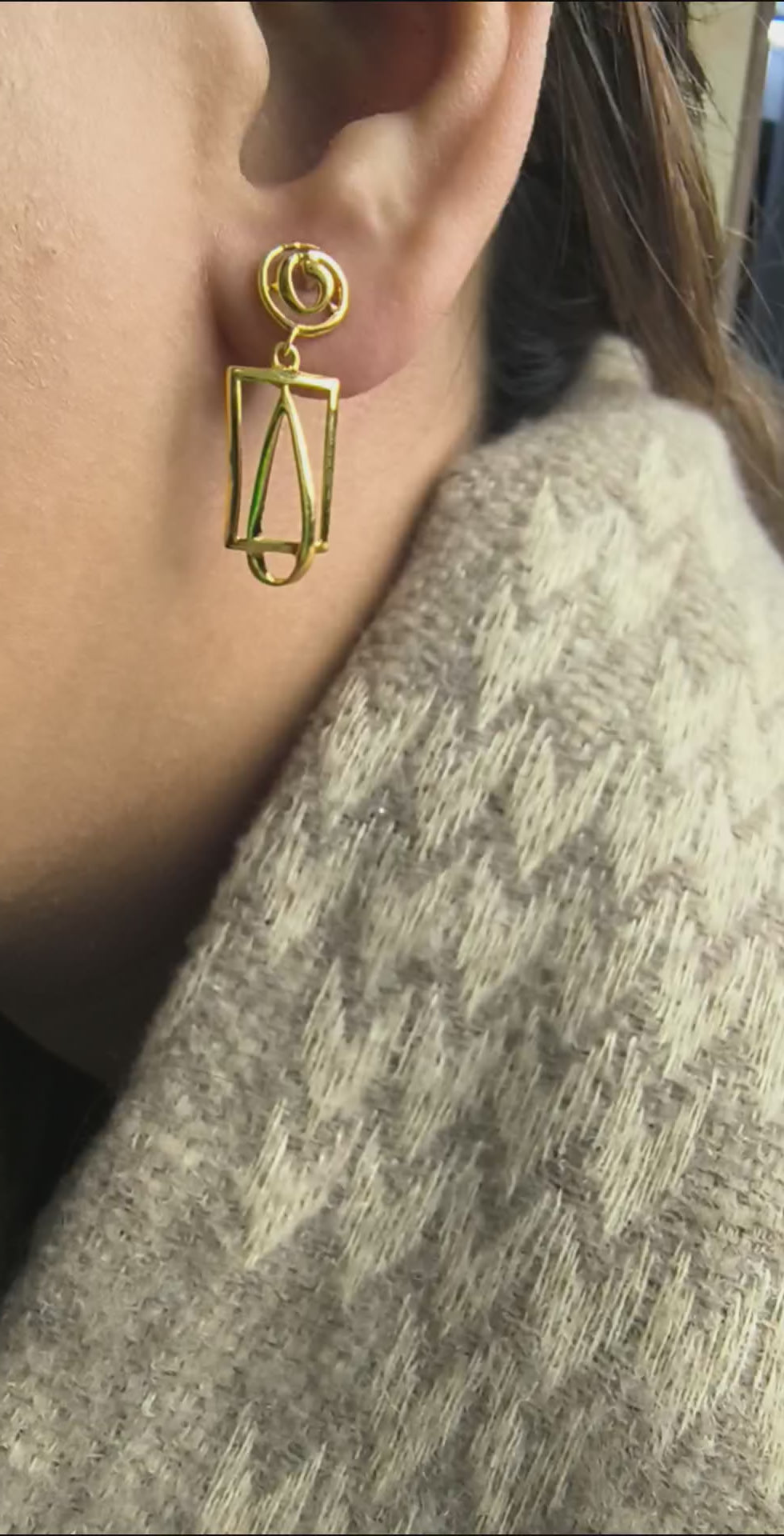 Close-up of 925 silver golden rectangular drop earrings worn on ear showing modern elongated geometric silhouette