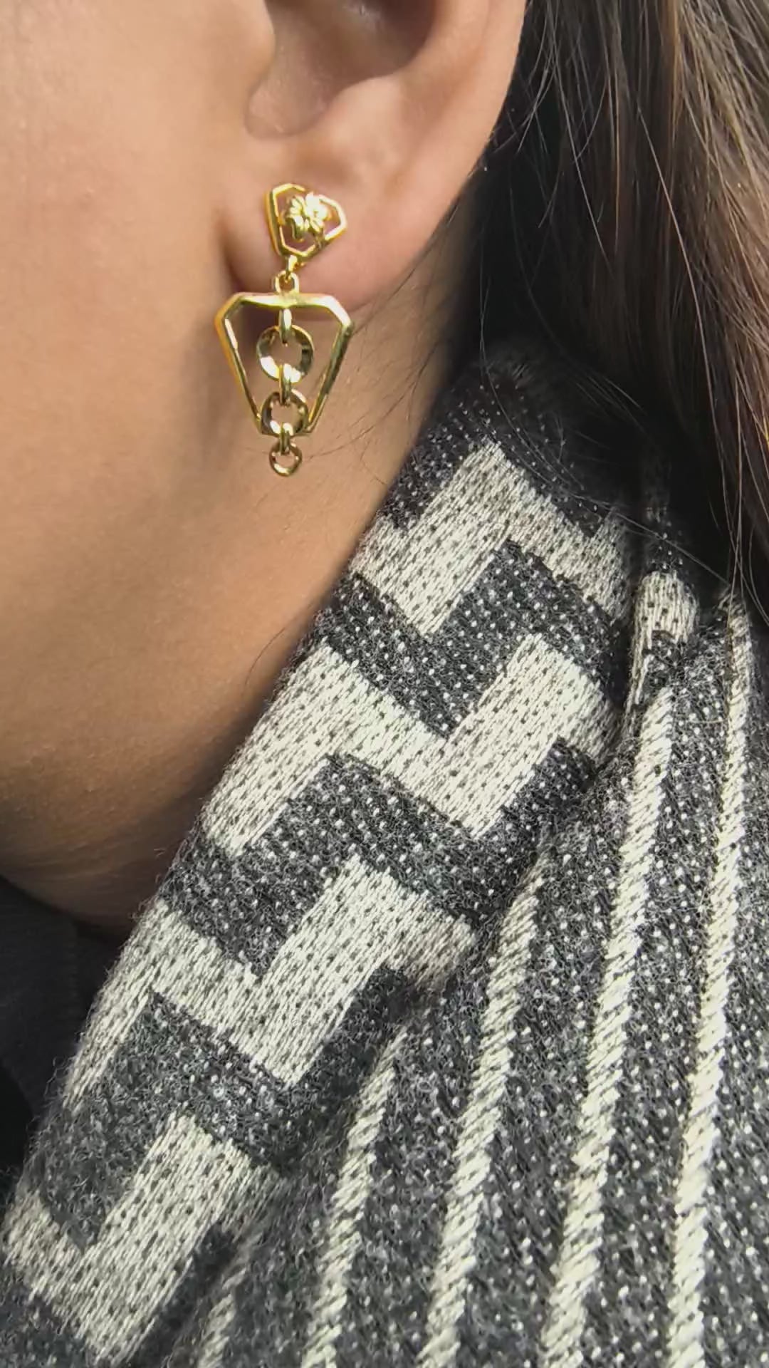 Close-up of 925 silver golden prism geometric drop earrings worn on ear showcasing modern structured silhouette