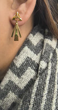 Close-up of 925 silver golden aura geometric drop earrings worn on ear highlighting modern triangular stud