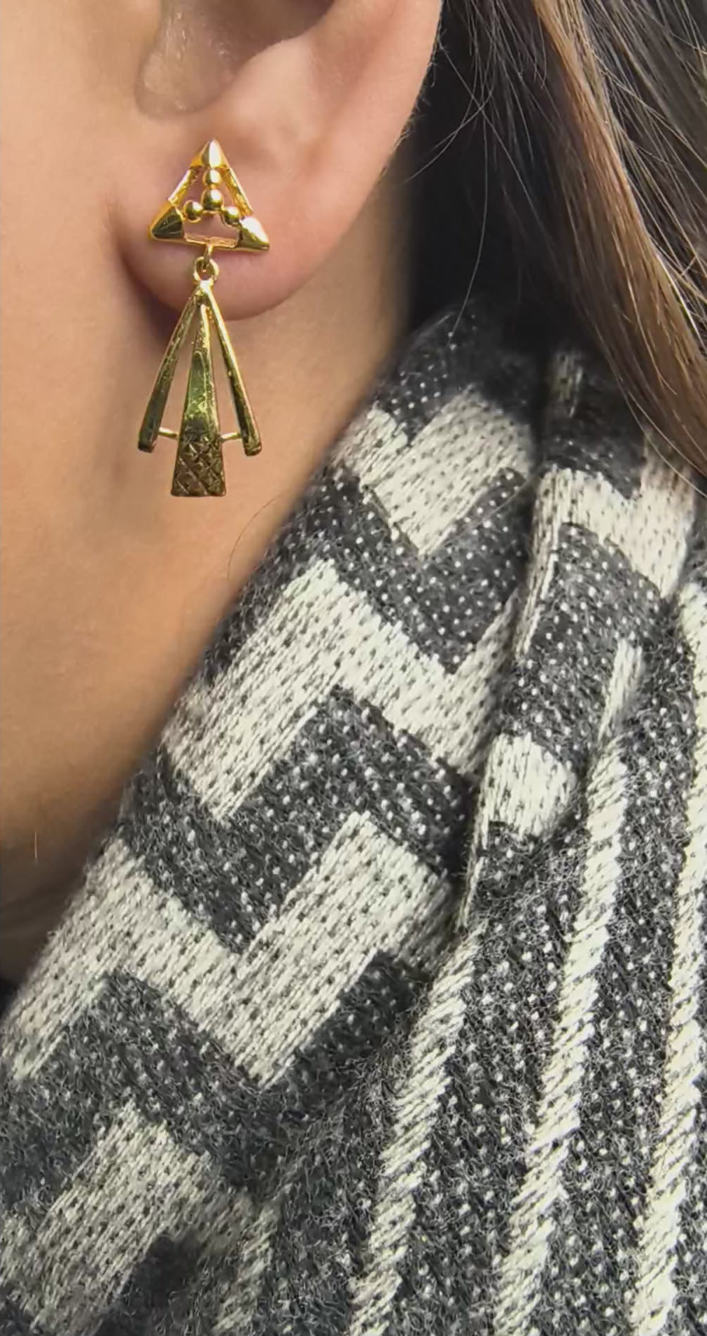 Close-up of 925 silver golden aura geometric drop earrings worn on ear highlighting modern triangular stud
