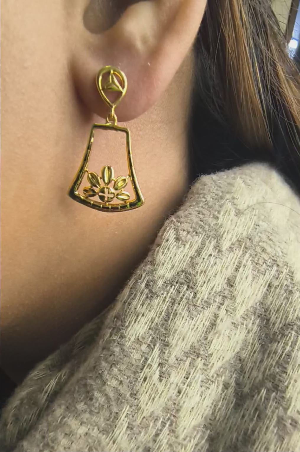 Close-up of 925 silver golden lotus bloom drop earrings worn on ear highlighting elegant traditional design