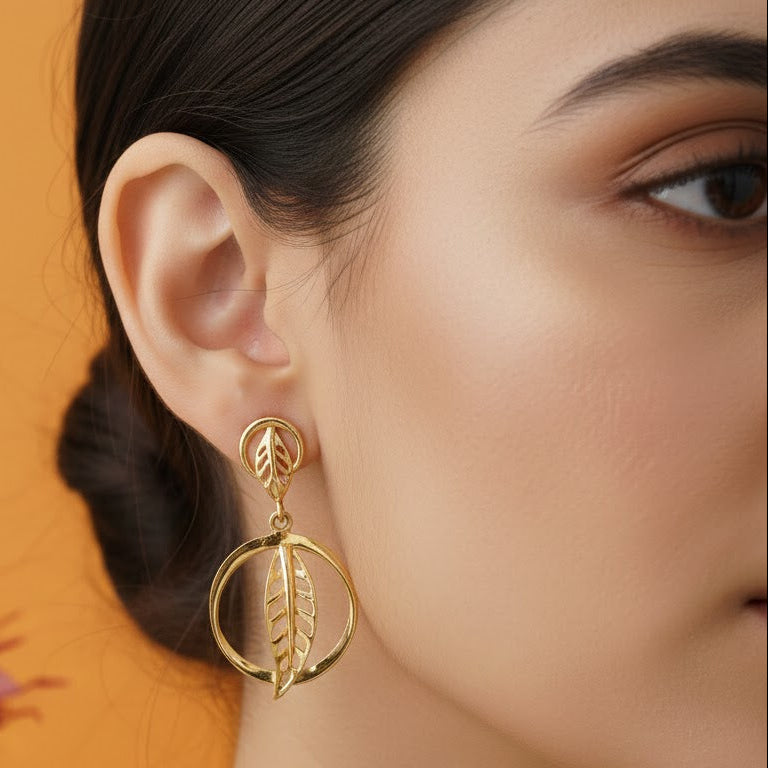 Close-up of 925 silver golden leaf circle drop earrings worn on ear showcasing elegant botanical silhouette
